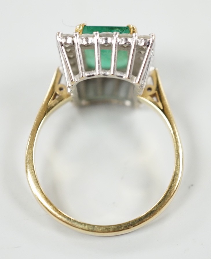 A modern 18ct gold, emerald and diamond set rectangular cluster ring, size Q, gross weight 6.4 grams.